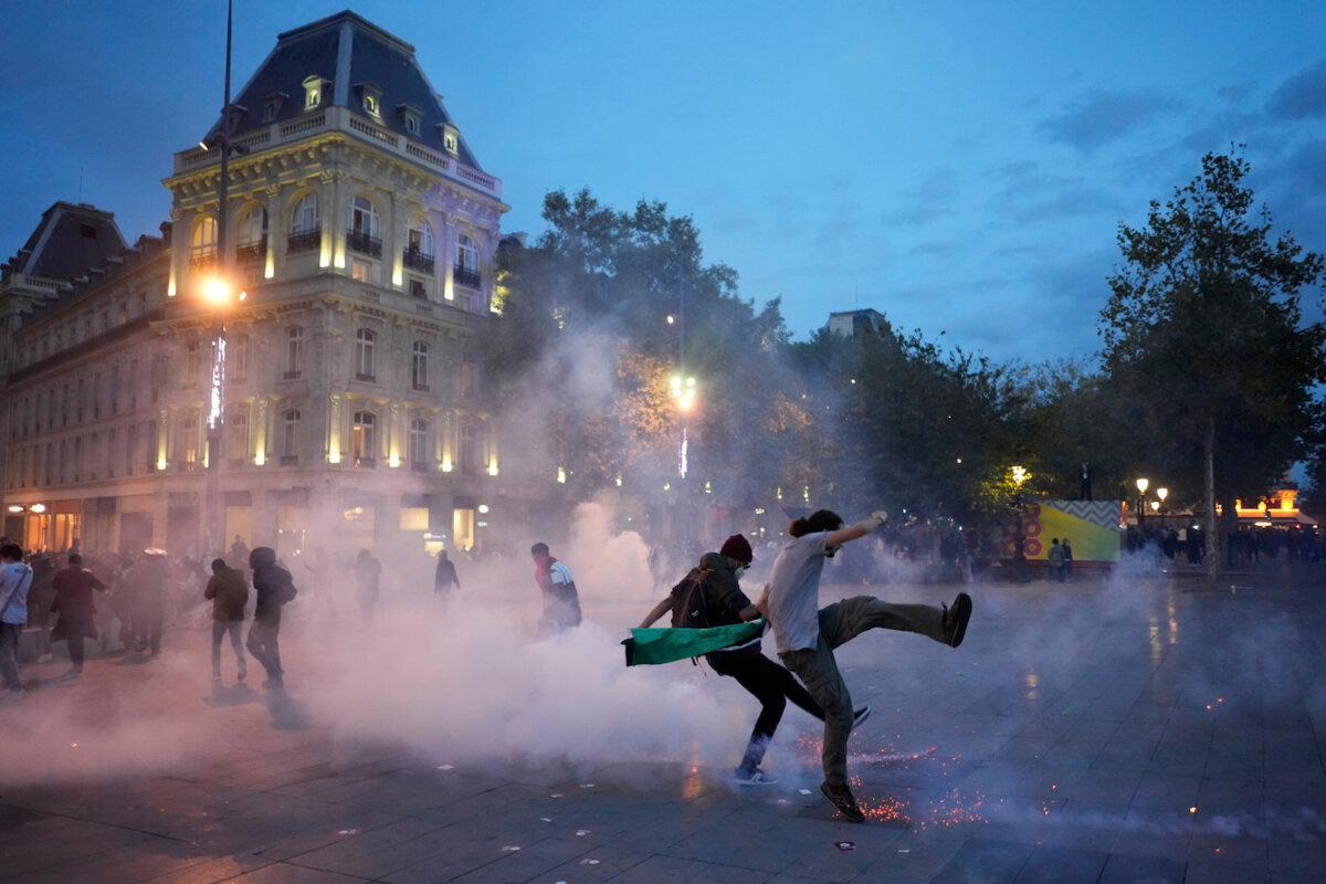 Protestors kick in a tear gas canister during a pro-Palestinian rally in Paris, France, on Oct.12, 2023. (Thibault Camus/AP Photo)
