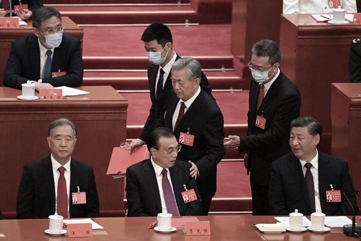 China's President Xi Jinping (R) watches as former president Hu Jintao (C) touches the shoulder of Premier Li Keqiang (2nd L) as he leaves the closing ceremony of the 20th Chinese Communist Party's Congress at the Great Hall of the People in Beijing on October 22, 2022. (NOEL CELIS/AFP via Getty Images)