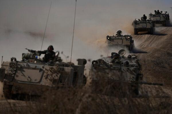 Israeli armoured personnel carriers head towards the Gaza Strip border in southern Israel, on Oct.13, 2023. (Ariel Schalit/AP)