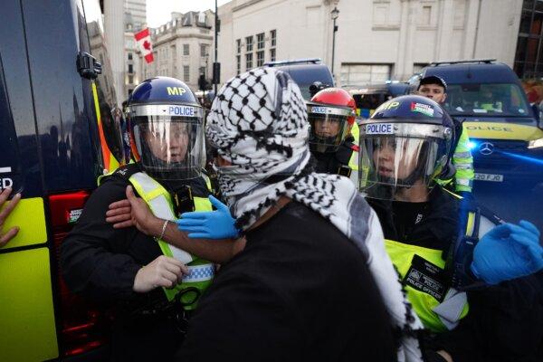 Police officers and protesters clash in Trafalgar Square during a March for Palestine in London on Oct. 14, 2023. (James Manning/PA)