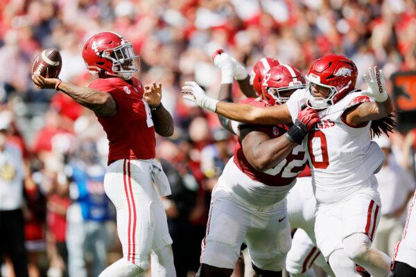 Jalen Milroe (4) of the Alabama Crimson Tide passes the ball over Nico Davillier (0) of the Arkansas Razorbacks during the first quarter at Bryant-Denny Stadium on Oct. 14, 2023. (Alex Slitz/Getty Images)