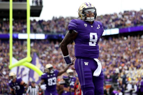 Michael Penix Jr. (9) of the Washington Huskies celebrates a touchdown against the Oregon Ducks during the first quarter at Husky Stadium in Seattle on Oct. 14, 2023. (Steph Chambers/Getty Images)