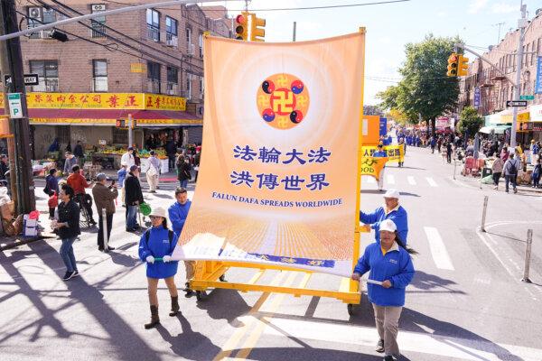 Falun Gong practitioners walk in a parade highlighting the Chinese regime's persecution of their faith, in Brooklyn, N.Y., on Oct. 15, 2023. (Larry Dye/The Epoch Times)