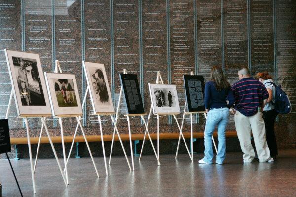 A file photo of visitors to the Museum of Tolerance viewing photos of Simon Wiesenthal, who was responsible for bringing more than 1,100 Nazi war criminals to trial, in Los Angeles on Sept. 20, 2005. (David McNew/Getty Images)