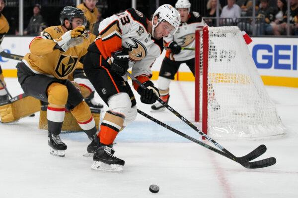Anaheim Ducks center Mason McTavish (23) vies for the puck with Vegas Golden Knights center Nicolas Roy (10) during the first period of an NHL hockey game in Las Vegas on Oct. 14, 2023. (John Locher/AP Photo)