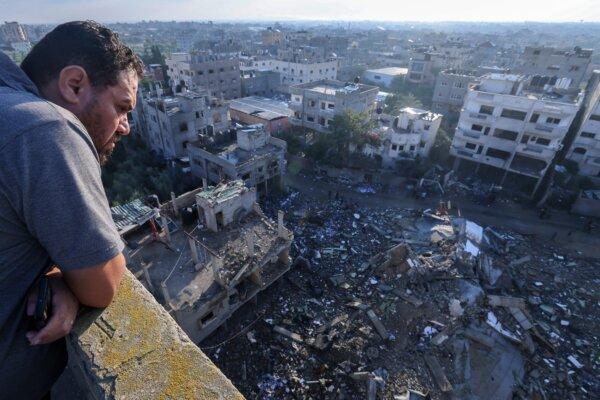 A Palestinian man looks at a building destroyed in an Israeli airstrike in the Rafah refugee camp in the Gaza Strip, on Oct. 16, 2023. (Mohammed Abed/AFP via Getty Images)