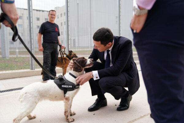 Justice Secretary Alex Chalk meets a search dog as he attends the official opening of HMP Fosse Way, a new Category C prison in Leicester, England. (Jacob King/PA )