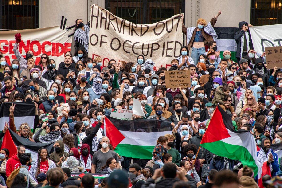 Protesters hold signs in support of Palestine “resistance” during a rally at Harvard University in Cambridge, Mass., on Oct. 14, 2023. (Joseph Prezioso/AFP via Getty Images)