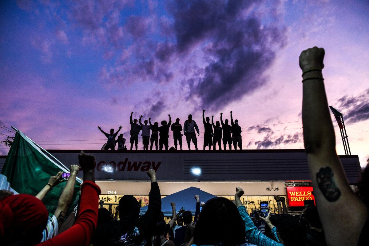 Protesters raise their hands and shout slogans in response to George Floyd's death in police custody, in Minneapolis, Minn., on June 2, 2020. (Chandan Khanna/AFP via Getty Images)