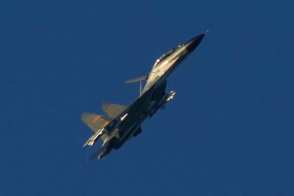 A Chinese J-11 military fighter jet flies above the Taiwan Strait near Pingtan, the closest land of mainland China to the island of Taiwan, in Pingtan in southeastern China's Fujian Province, on Aug. 5, 2022. (Ng Han Guan/AP Photo)