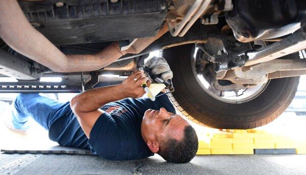 Deputy Jaime Moran from the L.A. County Sheriff's Department engraves a catalytic converter with a traceable number in City of Industry, Calif., on July 14, 2021. (Frederic J. Brown/AFP via Getty Images)