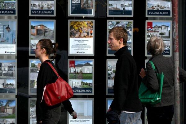 People walk past a real estate agency in Melbourne, Australia, on June 6, 2023. (William West/AFP via Getty Images)