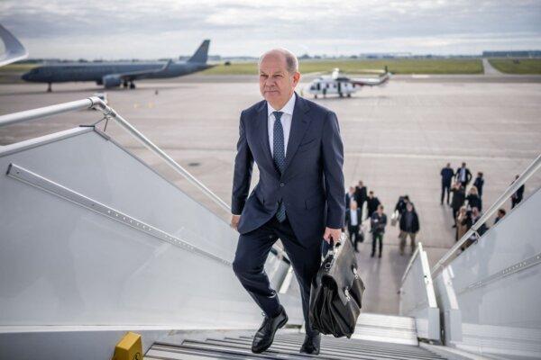 German Chancellor Olaf Scholz boards his plane at the military part of BER airport in Schoenefeld near Berlin before leaving for Israel on Oct. 17, 2023. (Michael Kappeler/Pool/AFP via Getty Images)