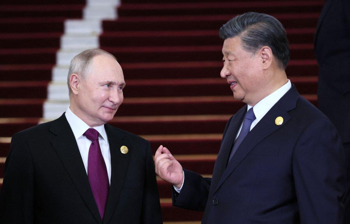 Russian President Vladimir Putin and Chinese leader Xi Jinping interacting during a welcoming ceremony at the Third Belt and Road Forum in Beijing, on Oct. 17, 2023. (Sergei Savostyanov/Pool/AFP via Getty Images)