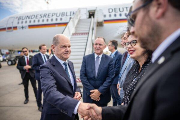 German Chancellor Olaf Scholz (C) shakes hands with delegation members after landing at the Ben Gurion airport in Tel Aviv, Israel, on Oct. 17, 2023. (Michael Kappeler/Pool/AFP via Getty Images)