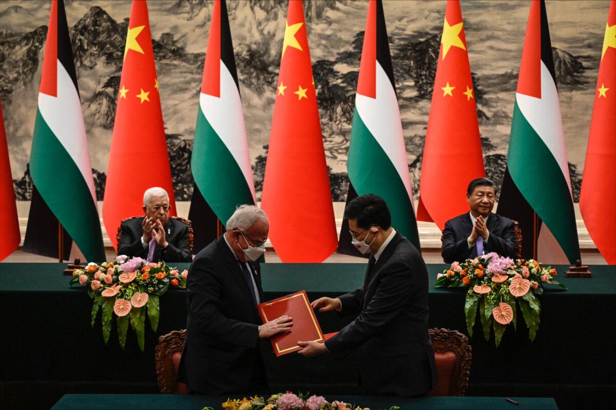 Palestinian Foreign Minister Riyad Al-Maliki (front L) attends a signing ceremony with Chinese Foreign Minister Qin Gang (front R) as Palestinian President Mahmoud Abbas (rear L) and China’s leader Xi Jinping (rear R) applaud, at the Great Hall of the People in Beijing, on June 14, 2023. (Jade Gao/Getty Images)