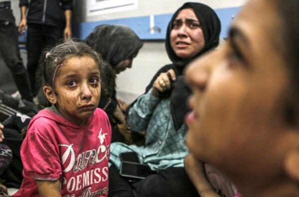 Wounded Palestinians sit in al-Shifa hospital in Gaza City, after arriving from al-Ahli Hospital following an explosion there, on Oct. 17, 2023. (Abed Khaled/AP)