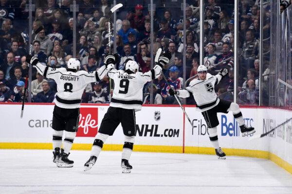 Los Angeles Kings' Pierre-Luc Dubois (80) celebrates his goal against the Winnipeg Jets with Drew Doughty (8) and Adrian Kempe (9) during the second period of an NHL hockey game, in Winnipeg, Manitoba, Oct. 17, 2023. (Fred Greenslade/The Canadian Press via AP)