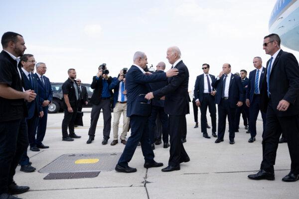 Israel Prime Minister Benjamin Netanyahu (L) greets U.S. President Joe Biden upon his arrival at Tel Aviv's Ben Gurion airport on Oct. 18, 2023. (Brendan Smialowski/AFP via Getty Images)