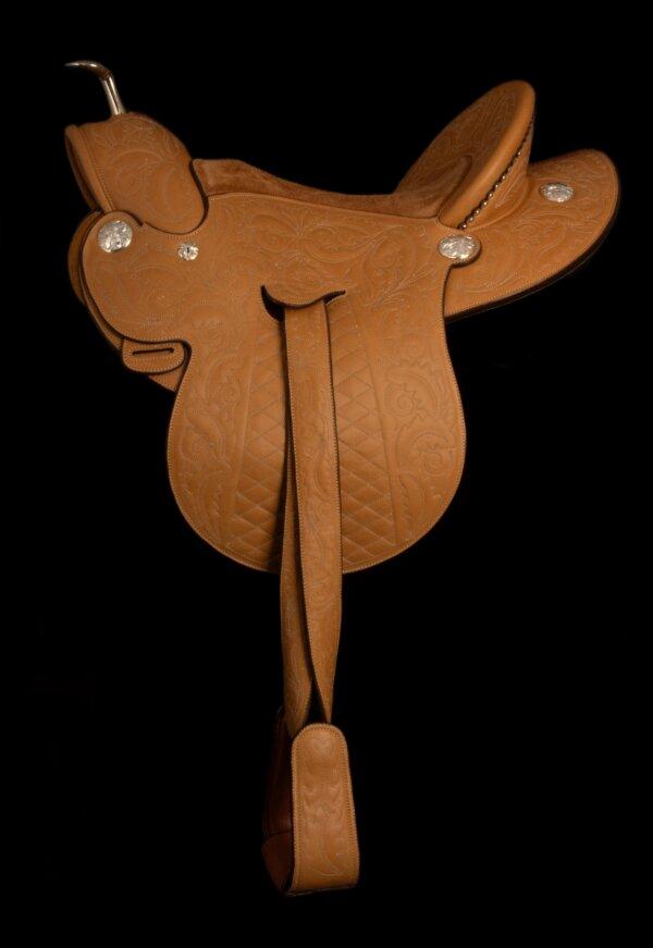 “Ladies Astride Saddle” by saddle maker Pedro Pedrini. Leather, wood, bronze, and silver. Handmade saddle tree (saddle frame) by saddle maker Bob Hamm. Hand engraved sterling silver mountings by silversmith Scott Hardy. (National Cowboy & Western Heritage Museum)