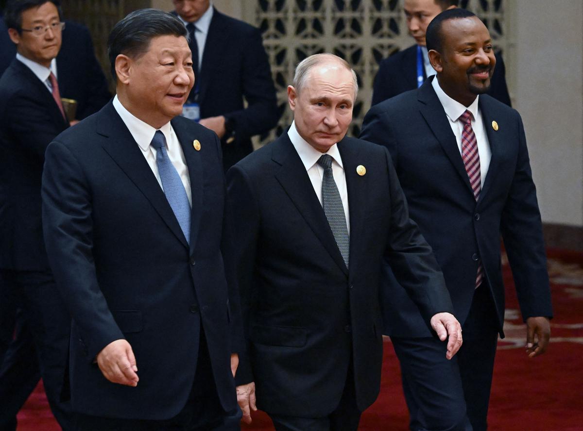 Russia's President Vladimir Putin (C) and Chinese Communist Party leader Xi Jinping (L) walk to a group photo session during the third Belt and Road Forum for International Cooperation at the Great Hall of the People in Beijing on Oct. 18, 2023. (Grigory Sysoyev/Pool/ AFP via Getty Images)