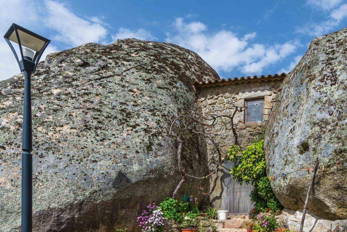 A house appears squished between two enormous rocks in the hamlet of Monsanto, Portugal. (Yuri Turkov/Shutterstock)