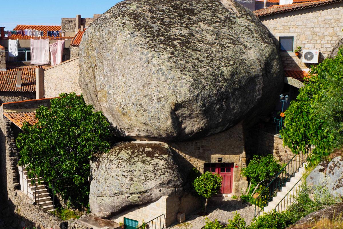 The restaurant Petiscos e Granito is embedded in an enormous boulder in Monsanto, Portugal. (Elena Kharichkina/Shutterstock)