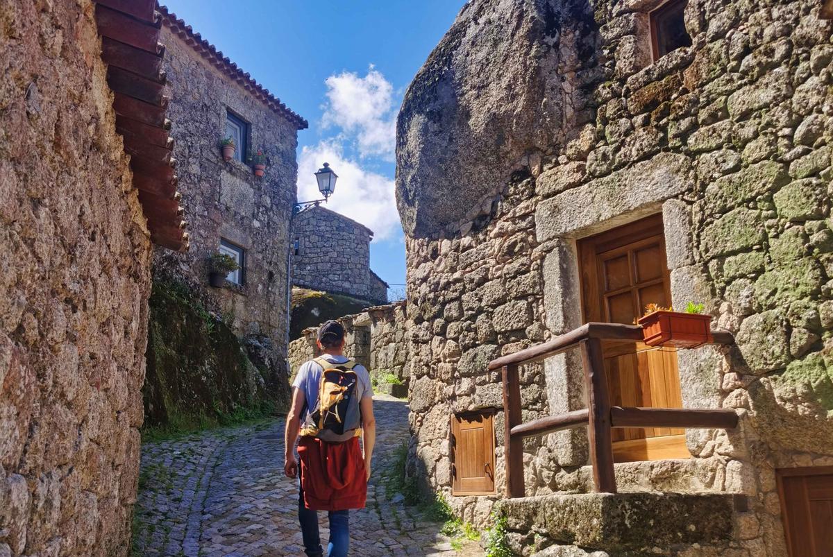 A traveler explores the narrow, cobbled streets of Monsanto, Portugal, where no vehicles are allowed. (Franck-A/Shutterstock)