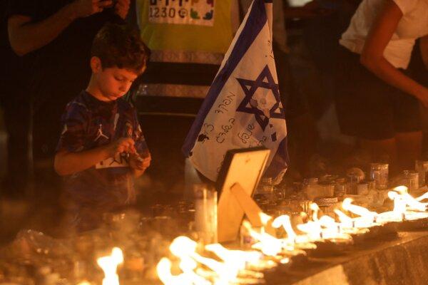 A boy lights a candle in memory of the victims of the Oct. 7 attack by Hamas terrorists on Israel, in Tel Aviv, on Oct. 18, 2023. (Ahmad Gharabli/AFP via Getty Images)