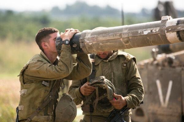 An Israeli soldier looks into a barrel of a tank on the Israeli border with the Gaza Strip in Sderot, Israel, on Oct. 19, 2023. (Amir Levy/Getty Images)