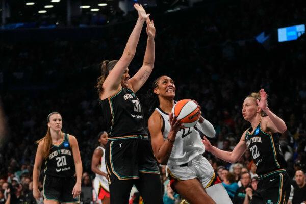Las Vegas Aces' A'ja Wilson (22) drives to the basket as New York Liberty's Stefanie Dolson (31) and Courtney Vandersloot (22) defends during the first half in Game 4 of a WNBA basketball finals in New York on Oct. 18, 2023. (Frank Franklin II/AP Photo)