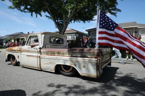A lowrider truck flies an American flag at the drive-by birthday party for World War II veteran Lt. Colonel Sam Sachs, who turned 105, in Lakewood, Calif., on April 26, 2020. (Mario Tama/Getty Images)