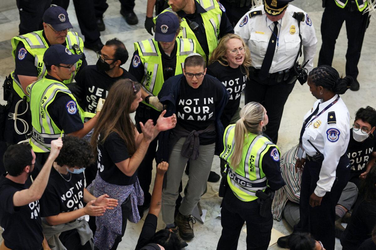 Capitol Police officers detain protesters as they hold a demonstration in support of a cease-fire against the Palestinians in Gaza in the Cannon House Office Building in Washington on Oct. 18, 2023. (Alex Wong/Getty Images)