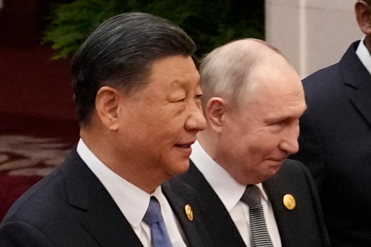 Chinese leader Xi Jinping (L) and Russian President Vladimir Putin prepare for a group photo with other leaders at the third Belt and Road Forum in Beijing on Oct. 18, 2023. (Suo Takekuma/Pool via Getty Images)