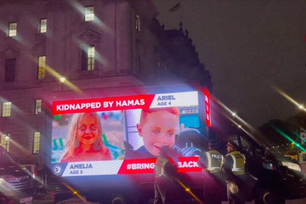 Screenshot taken with permission from a video posted on X by Campaign Against Antisemitism showing Metropolitan Police officers at a billboard van displaying information of children taken hostage by the Hamas terrorist group, in central London on Oct. 18, 2023. (Campaign Against Antisemitism/Screenshot via The Epoch Times)