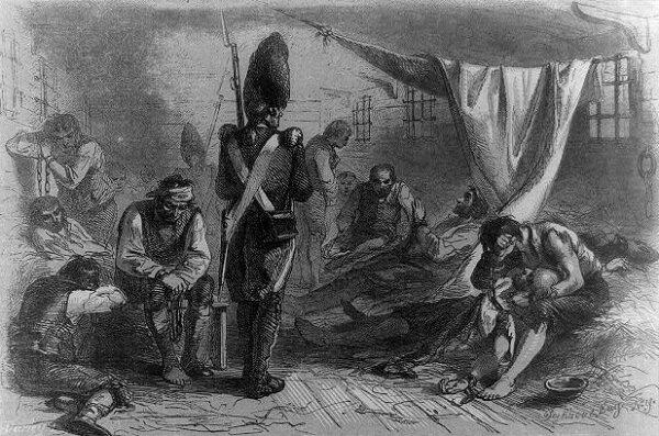 Inside the Jersey, a British prison ship during the Revolutionary War, showing prisoners and a guard. (Public Domain)