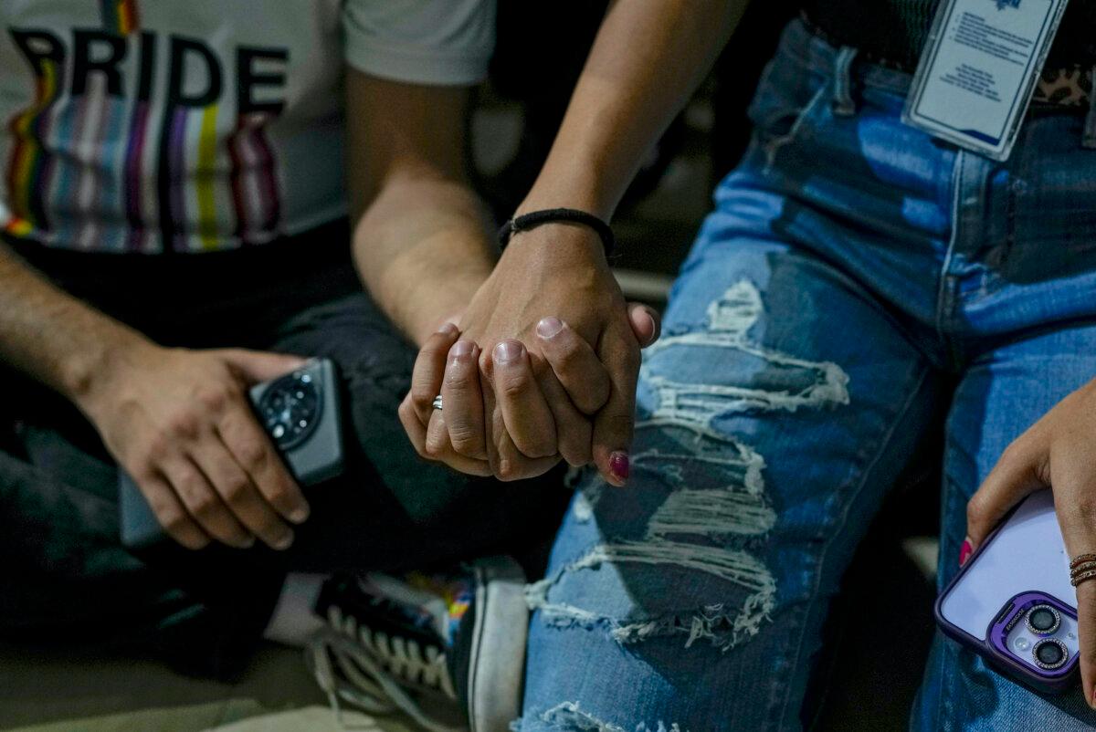 LGBTQ community supporters and members hold each other hand as they watch the Supreme Court verdict on petitions that seek the legalization of same-sex marriage, in Mumbai, India, Tuesday, Oct. 17, 2023. (Rafiq Maqbool/AP Photo)