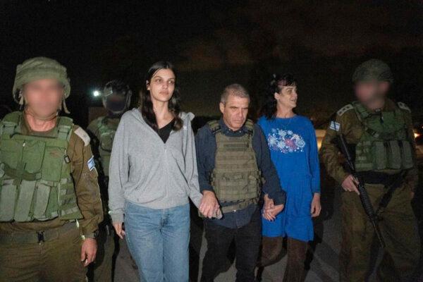 Judith Raanan, right, and her 17-year-old daughter Natalie are escorted by Israeli soldiers and Gal Hirsch, Prime Minister Benjamin Netanyahu's special coordinator for returning the hostages, as they return to Israel from captivity in the Gaza Strip on Oct. 20, 2023. (Government of Israel via AP Photo)