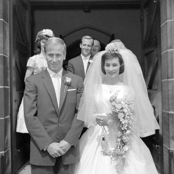 Bobby Charlton, the Manchester United and England football star, and his bride, twenty-one-year-old fashion model Norma Ball, leave St. Gabriel's church in Middleton, near Manchester, England, after their wedding, July 22, 1961. (AP Photo/File)