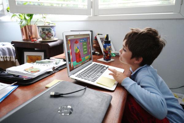 A student does school work on a laptop while being home-schooled in Sydney, Australia, on April 9, 2020. (Brendon Thorne/Getty Images)