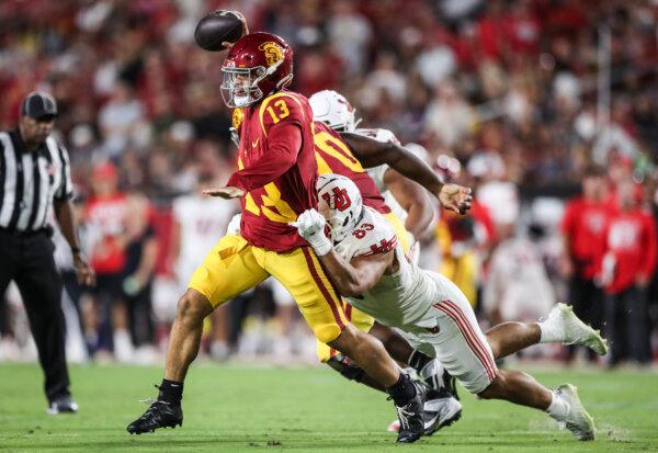 Caleb Williams (13) of the USC Trojans looks to throw a pass defended by Jonah Elliss (83) of the Utah Utes in the second quarter at United Airlines Field at the Memorial Coliseum in Los Angeles on Oct. 21, 2023. (Meg Oliphant/Getty Images)