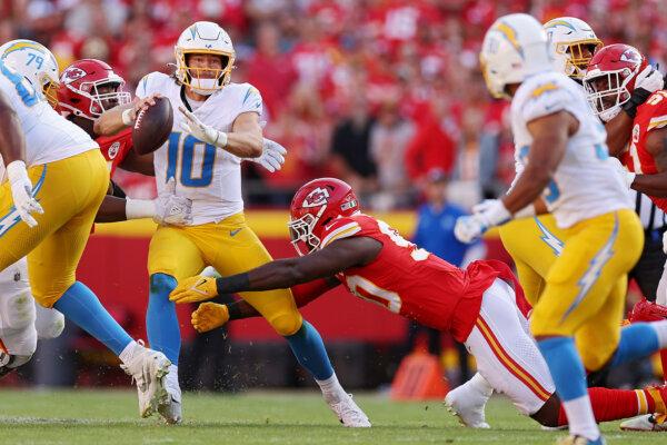 Justin Herbert (10) of the Los Angeles Chargers is sacked during the first quarter against the Kansas City Chiefs at Arrowhead Stadium in Kansas City on Oct. 22, 2023. (Jamie Squire/Getty Images)