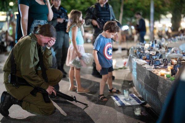 People gather and light candles to remember the victims who were murdered by Hamas terrorists at Dizengoff Square in Tel Aviv on Oct. 22, 2023. (Dima Vazinovich/Middle East Images/Middle East Images via AFP via Getty Images)