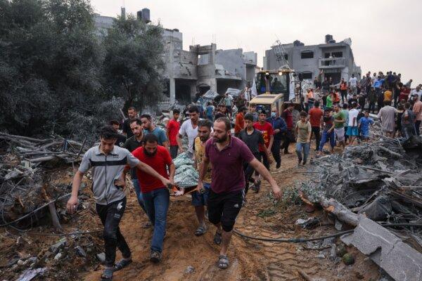 Palestinians transport the body of a victim from the rubble after Israeli strikes in Rafah in the southern Gaza Strip on Oct. 23, 2023. (Mohammed Abed/AFP via Getty Images)