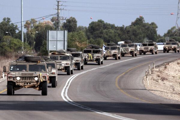 A convoy of Israeli army vehicles drives along a road close to the southern Israeli city of Sderot on Oct. 23, 2023. (Thomas Coex/AFP via Getty Images)