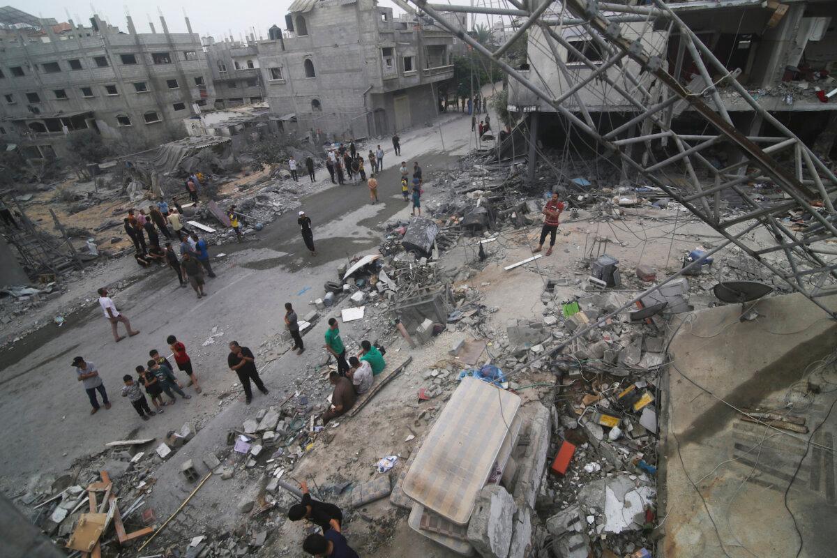 Palestinians look for survivors after an Israeli bombardment of the Gaza Strip in Rafah, on Oct. 23, 2023. (Hatem Ali/AP Photo)