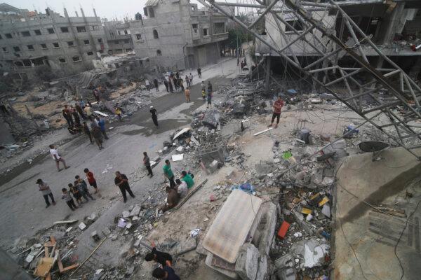 Palestinians look for survivors after an Israeli bombardment of the Gaza Strip in Rafah on Oct. 23, 2023. (Hatem Ali/AP Photo)