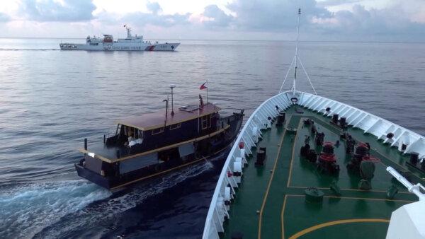 A Philippine-flagged boat is blocked by a China Coast Guard vessel in the South China Sea in this screen grab obtained from a video released on October 22, 2023. (China Coast Guard via Reuters)