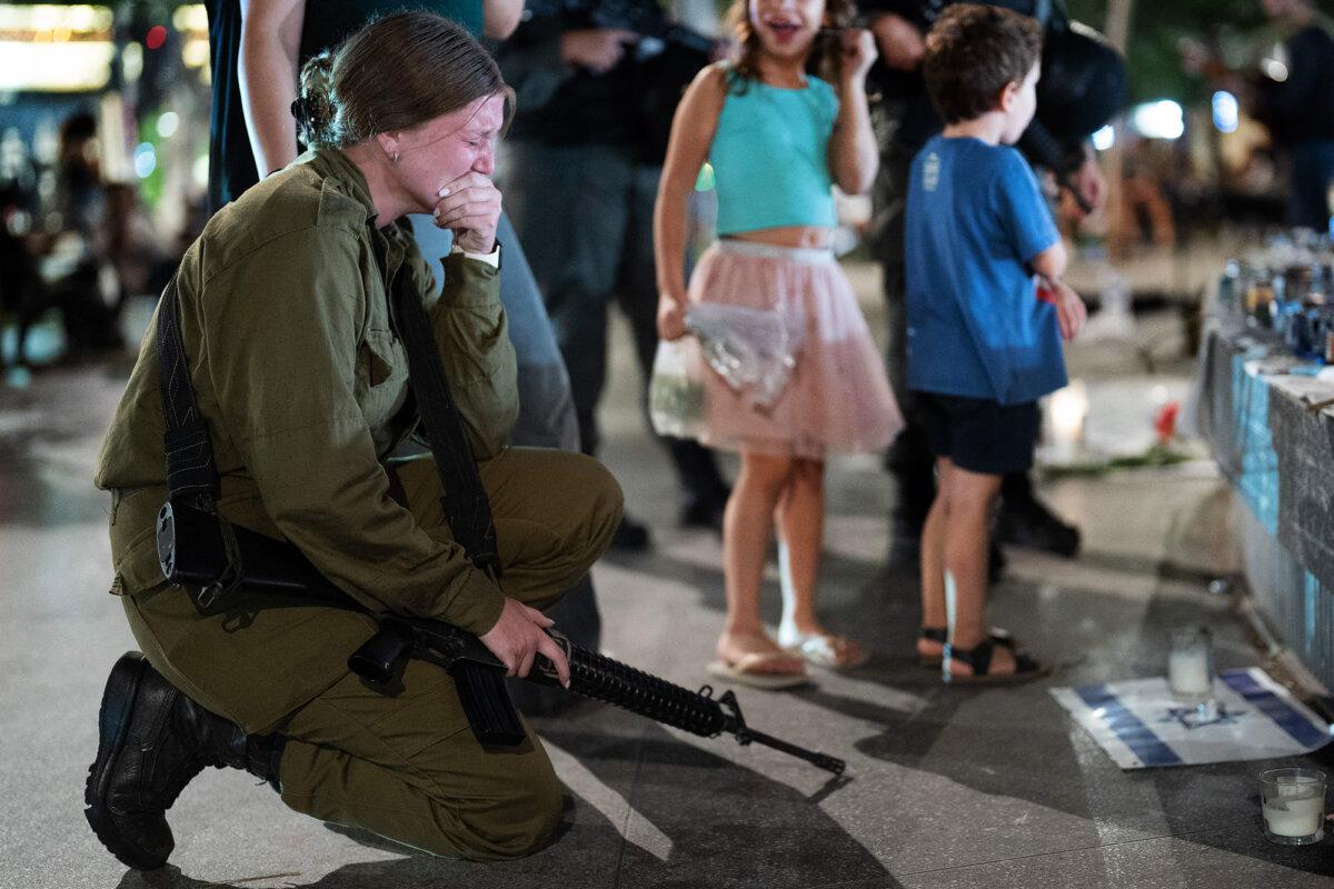 An Israeli soldier remembers those murdered by Hamas terrorists at a rally in Dizengoff Square in Tel Aviv, on Oct. 22, 2023. (Dima Vazinovich/Middle East Images via AFP via Getty Images)