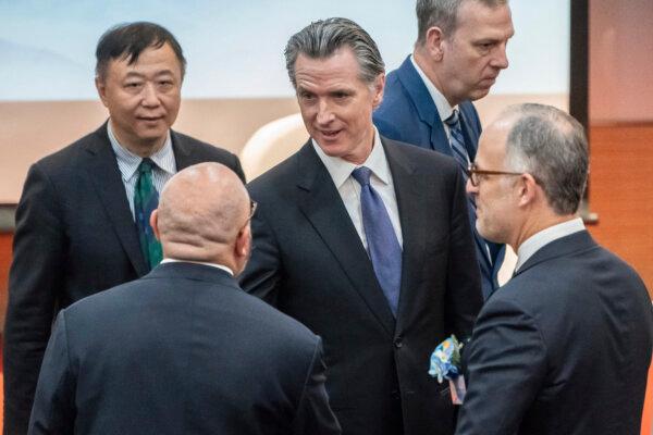 Visiting California Gov. Gavin Newsom (C) is greeted by guests as he arrives to attend the fireside chat at the Hong Kong University in Hong Kong on Oct. 23, 2023. (Anthony Kwan/AP Photo)